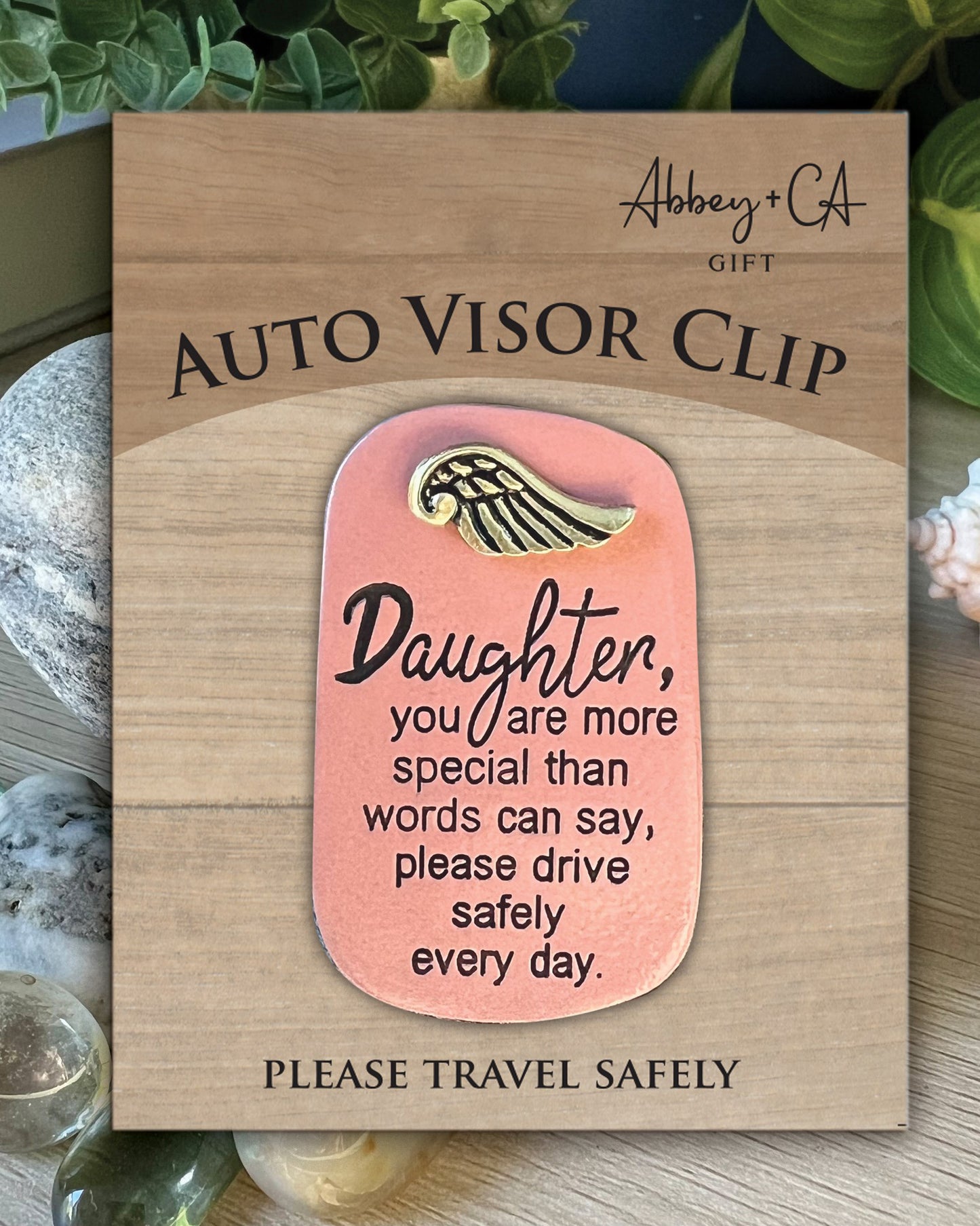 Auto visor clip with motivational message on a wooden card, brand 'Abbey & Co' visible