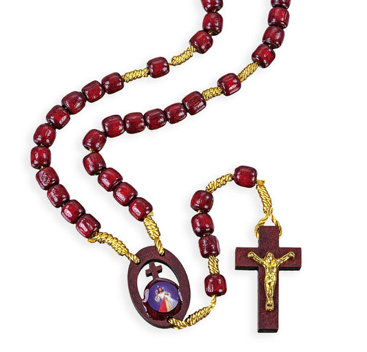 Wooden rosary with red beads and gold accents on a white background