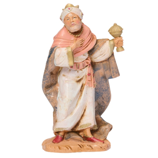 Figurine of a wise man from a nativity scene on a white background