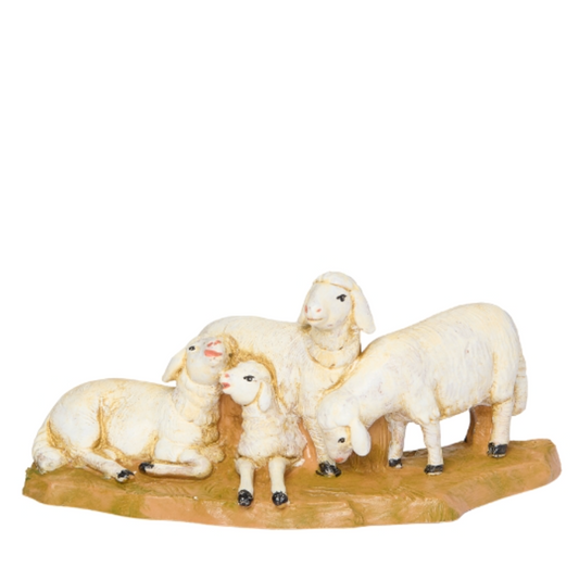 Sheep figurines on a wooden base against a white background
