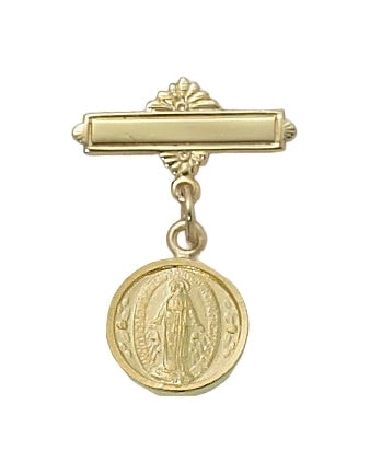 A gold-toned religious tie bar featuring a decorative horizontal bar with a floral crest and a dangling circular Miraculous Medal charm, shown against a plain white background.