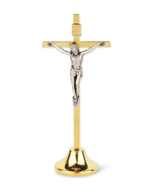 Gold and silver crucifix on a white background