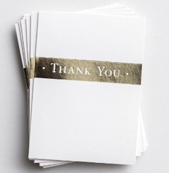 Stack of white cards with 'Thank You' text on a light gray background