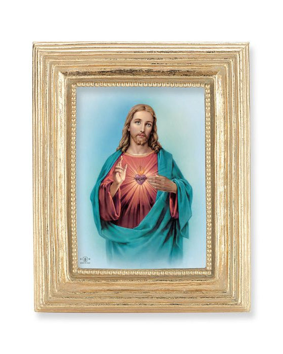 Framed artwork of a religious figure with a gold frame on a white background