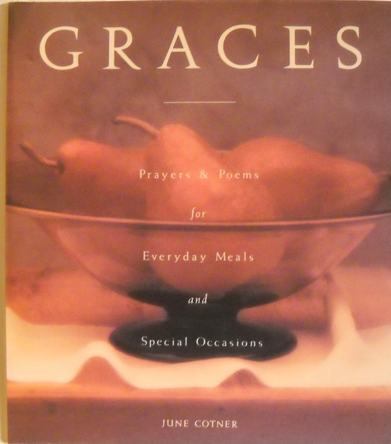 Book cover of 'Graces' with a bowl of pears and text about prayers and poems for meals.