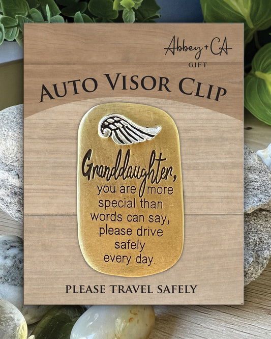 Wooden card with gold tag and text message, placed on a natural background.
