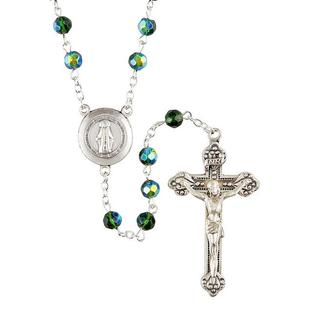 A Prague collection rosary featuring green fire-polished beads, a silver oxidized crucifix, and a centerpiece with the Miraculous Medal.