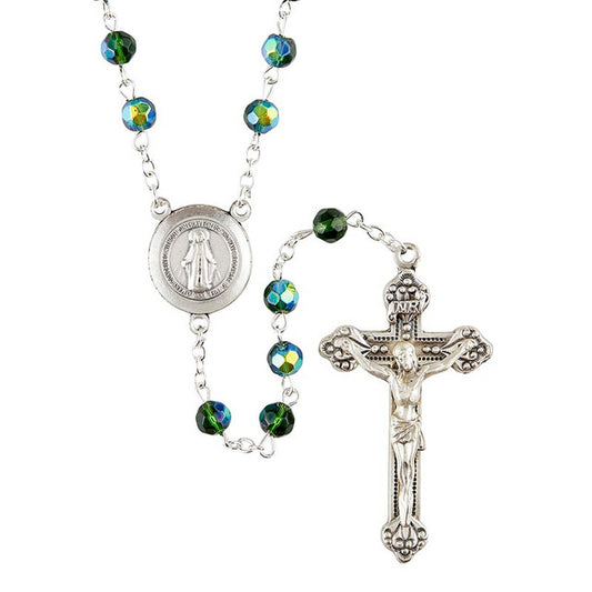A Prague collection rosary featuring green fire-polished beads, a silver oxidized crucifix, and a centerpiece with the Miraculous Medal.