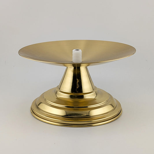 Gold-colored metal base with a white screw on a light gray background