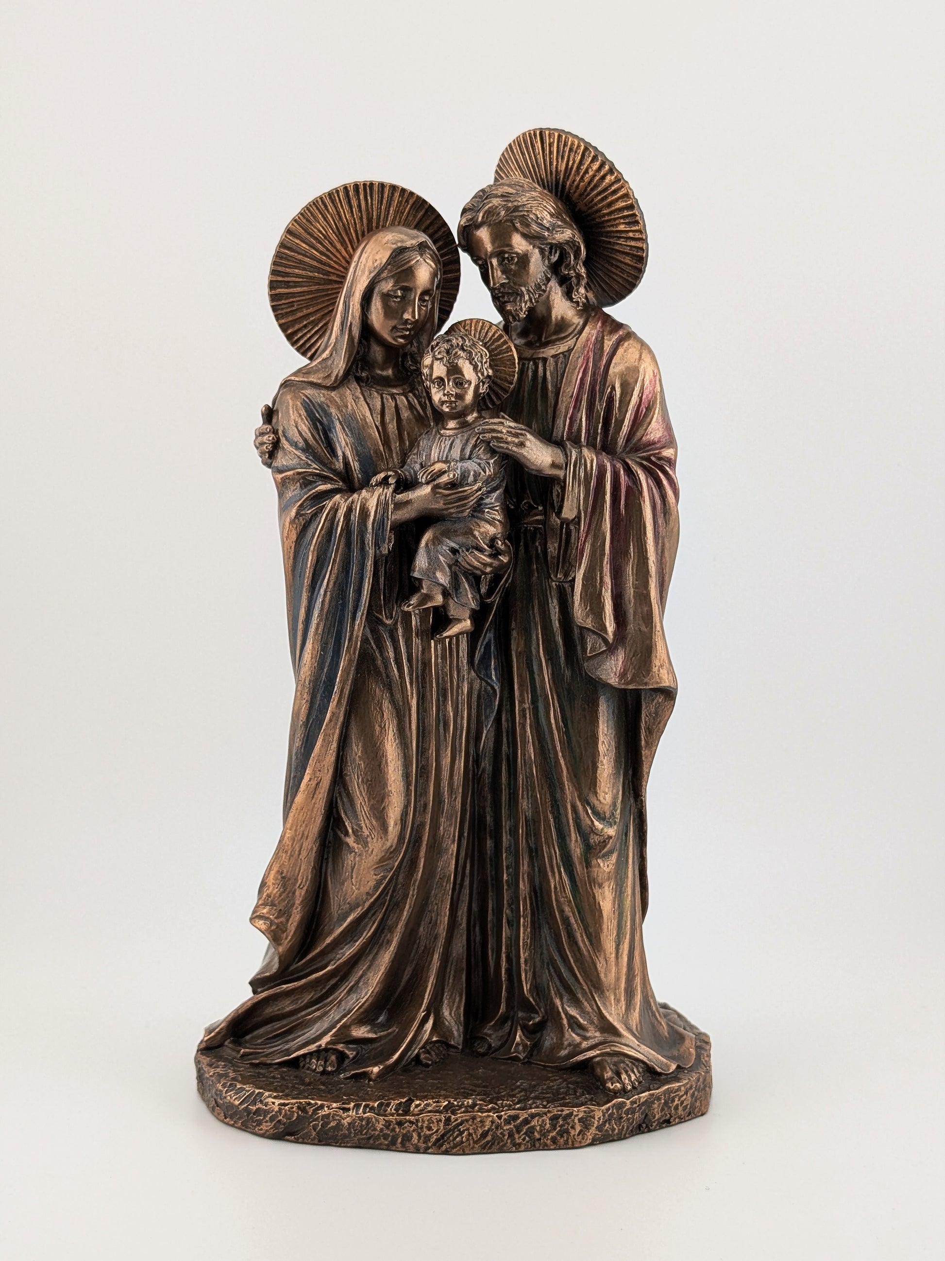 Bronze statue of a family with a child on a white background