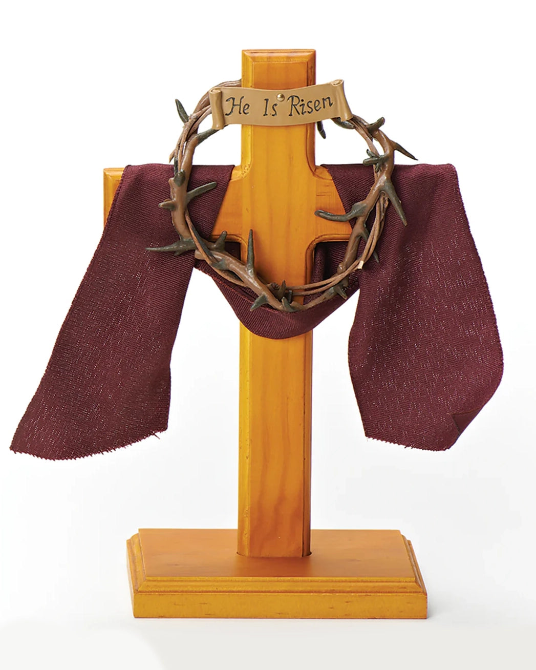 Wooden cross with 'He Is Risen' inscription and a wreath on a white background