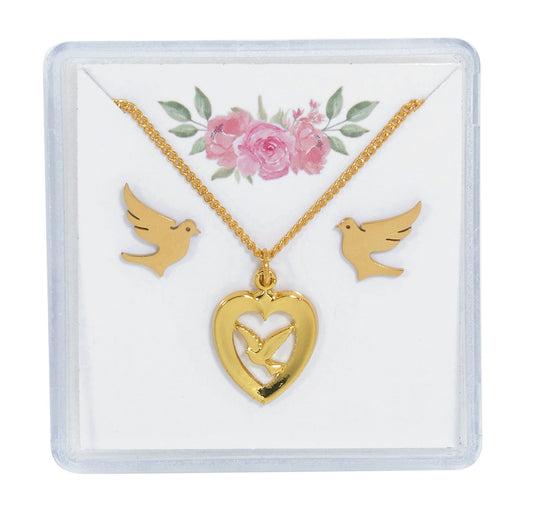 A gold tone necklace and earrings set with a dove and a heart with a cross pendant, presented on a card with floral design.