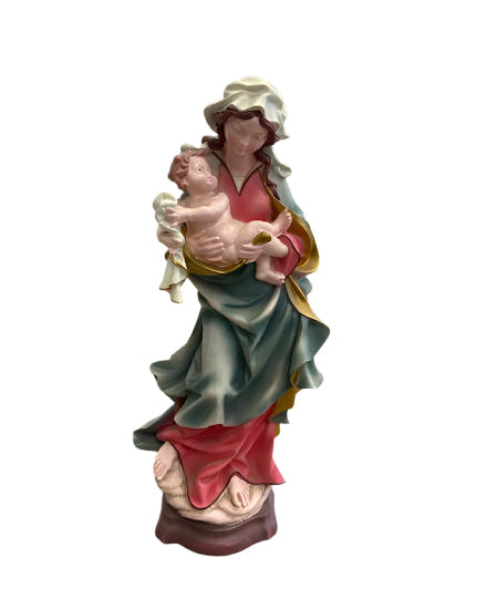 Colorful angel figurine on a stone surface with a display of books and frames in the background.