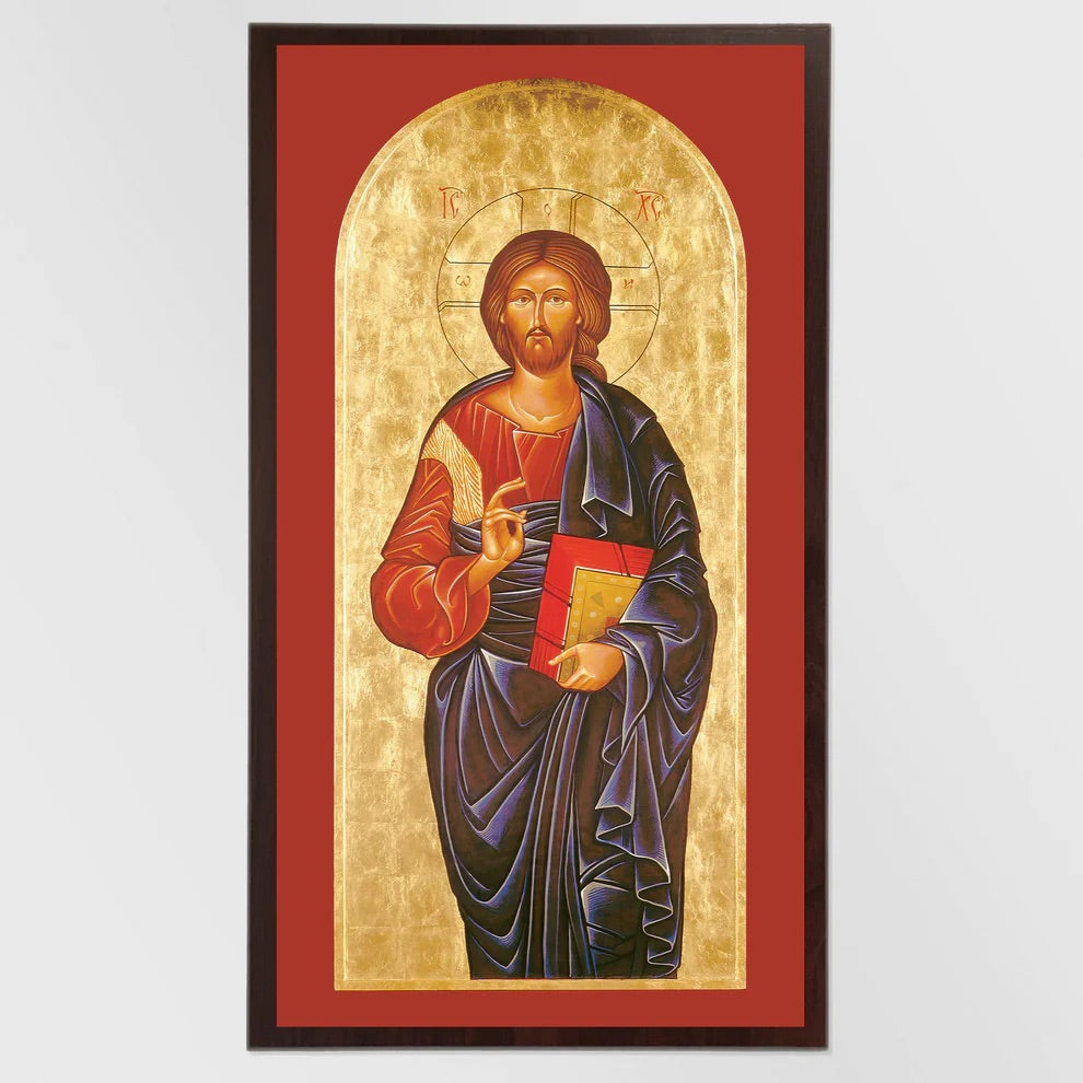 Framed artwork of a religious figure holding a book on a red background