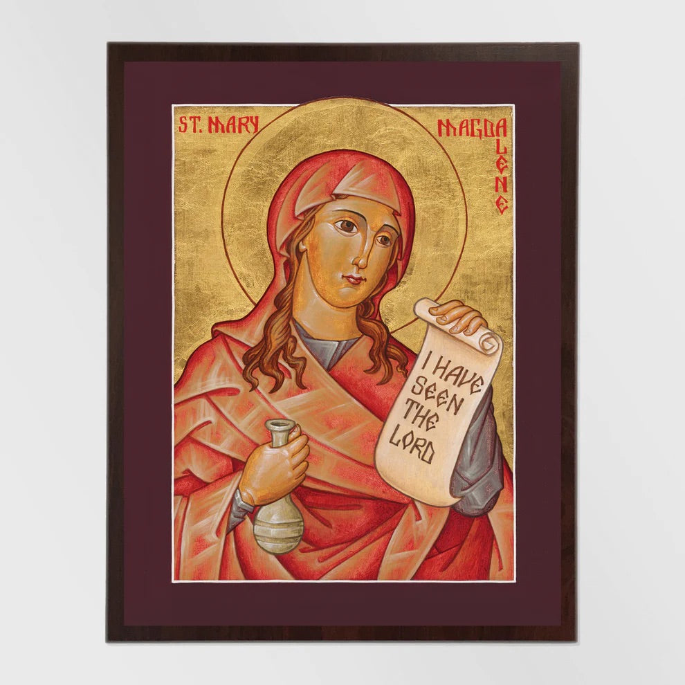 Framed artwork of a religious figure holding a scroll with text, on a plain background