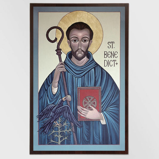 Framed artwork of Saint Benedict holding a book and staff on a light blue background