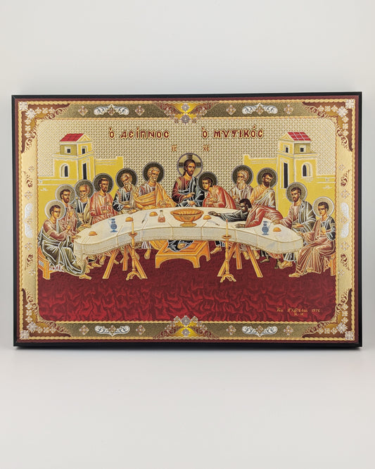 Icon of the Last Supper with ornate gold and red frame on a white background