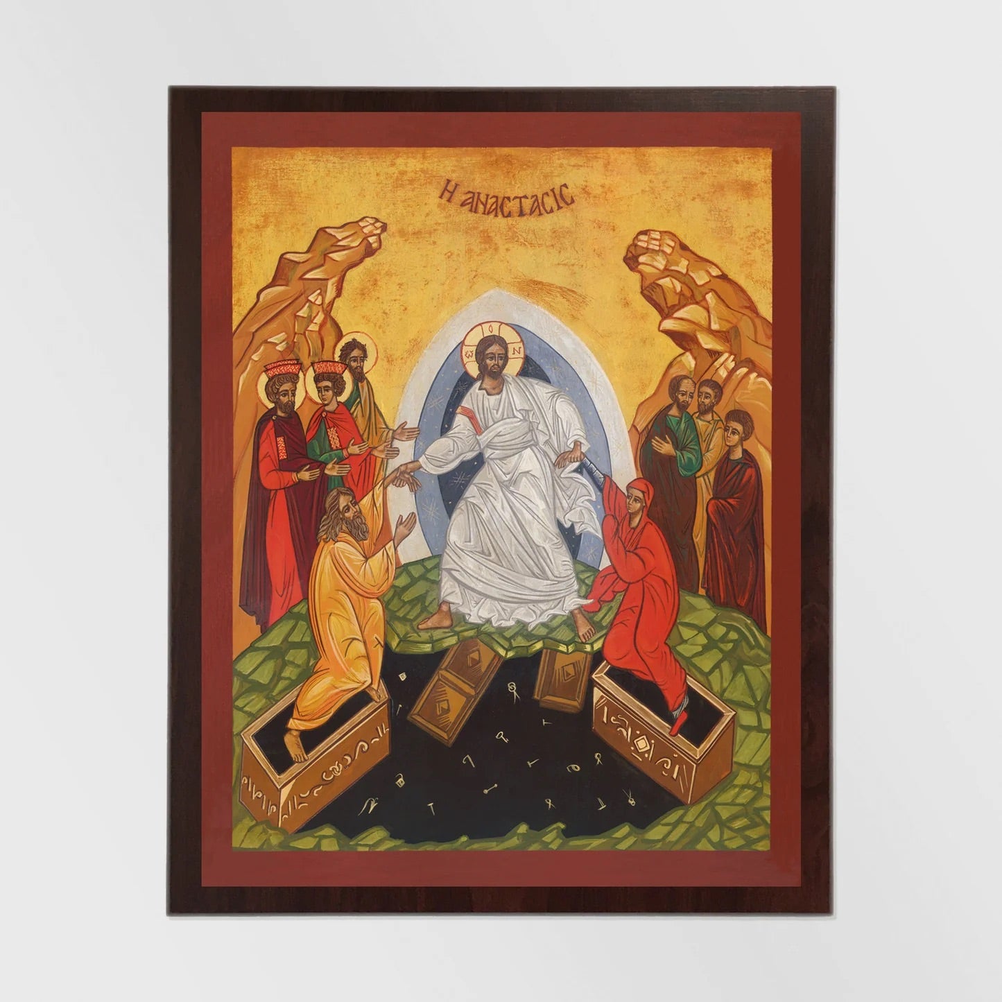 Framed artwork depicting a religious scene with figures and an arch, on a white background.