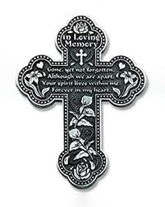 Decorative cross with floral elements and text in a black and white color scheme.