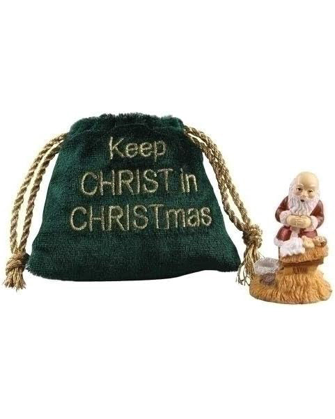 Green drawstring bag with 'Keep CHRIST in CHRISTmas' text and a small figurine of a man in a basket on a white background.
