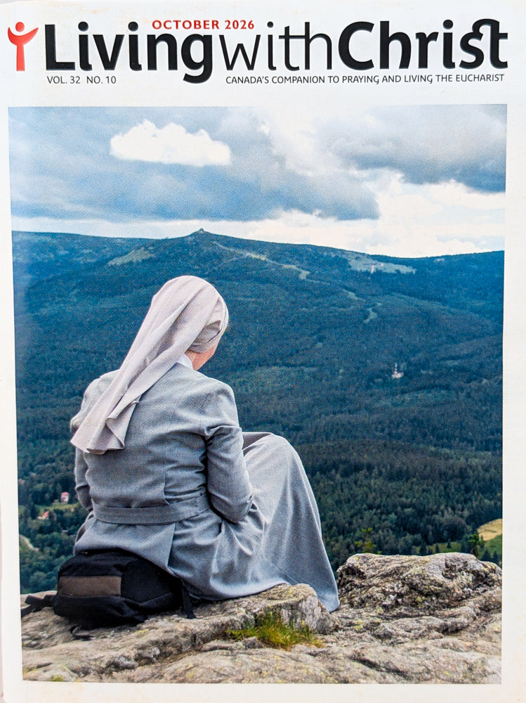 October 2026 issue cover of Living with Christ magazine, featuring a nun in a gray habit sitting on a rocky mountain peak with a forested valley and cloudy sky behind her. The title 'Living with Christ' is printed at the top.