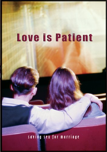 Two people sitting together with a screen displaying 'Love is Patient' in a movie theater setting.