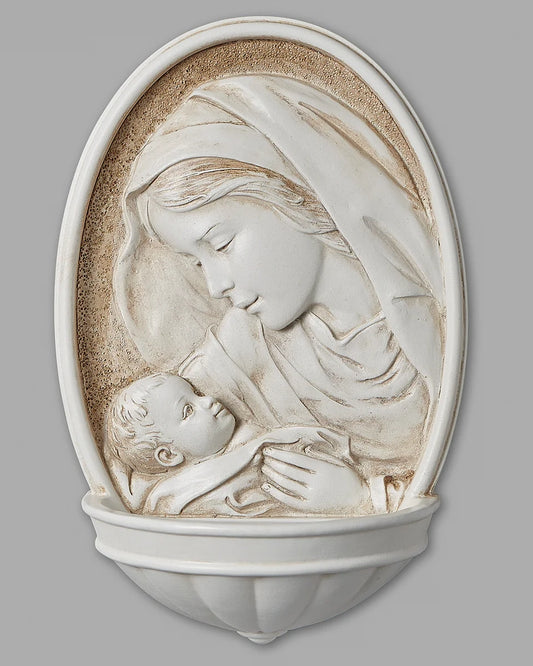 Decorative wall piece of a mother holding a child against a gray background