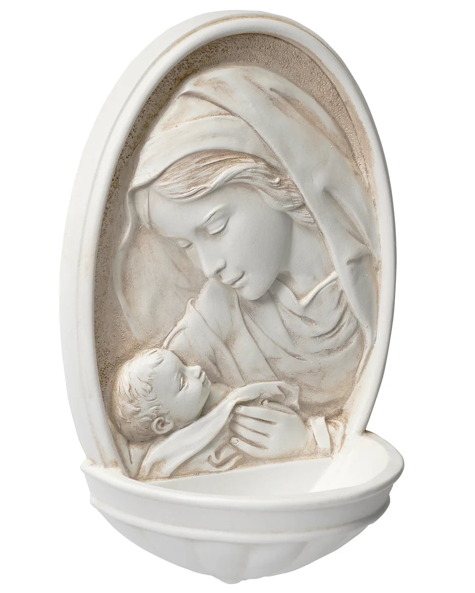 Decorative wall art of a mother holding a child in an oval frame.