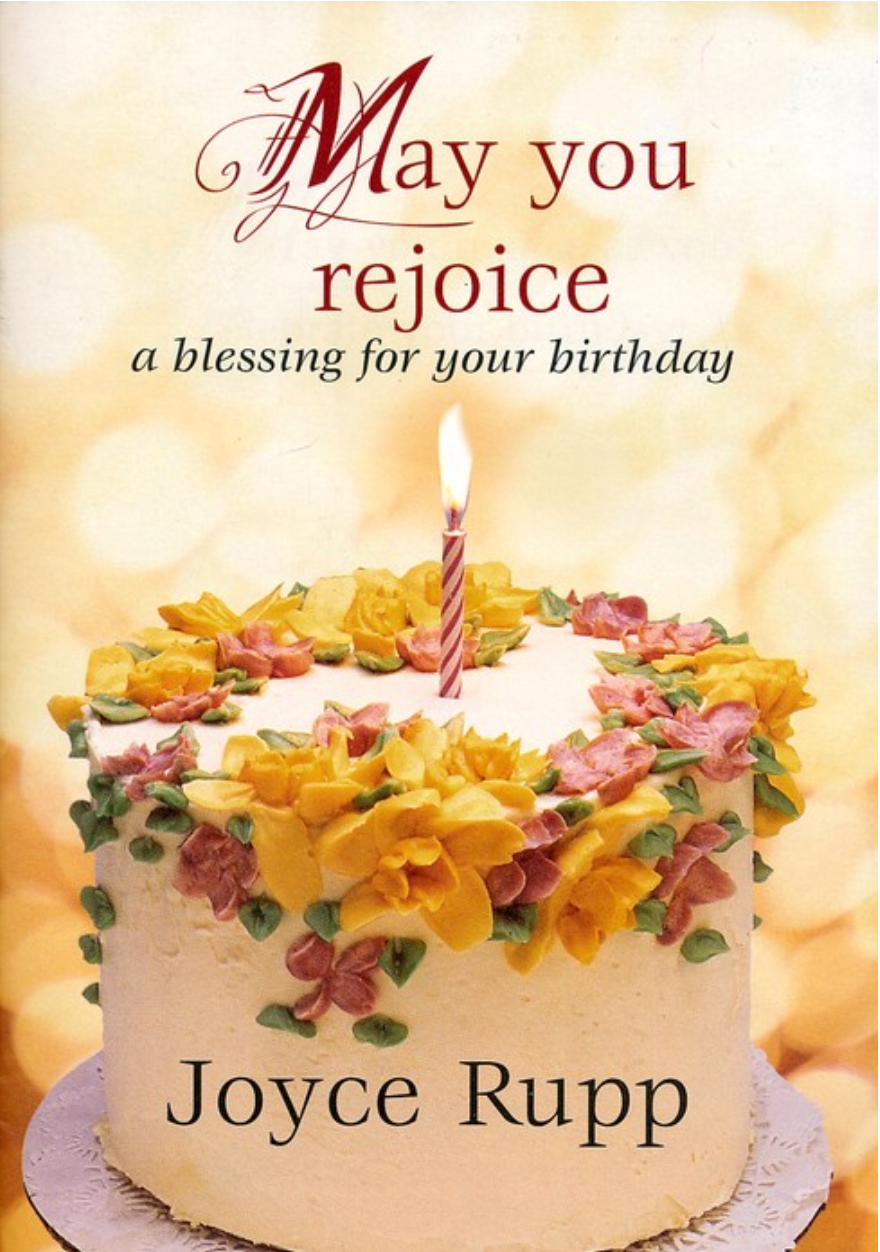 Book cover for May you Rejoice by Joyce Rupp. A cake with a single candle on a yellow background. 