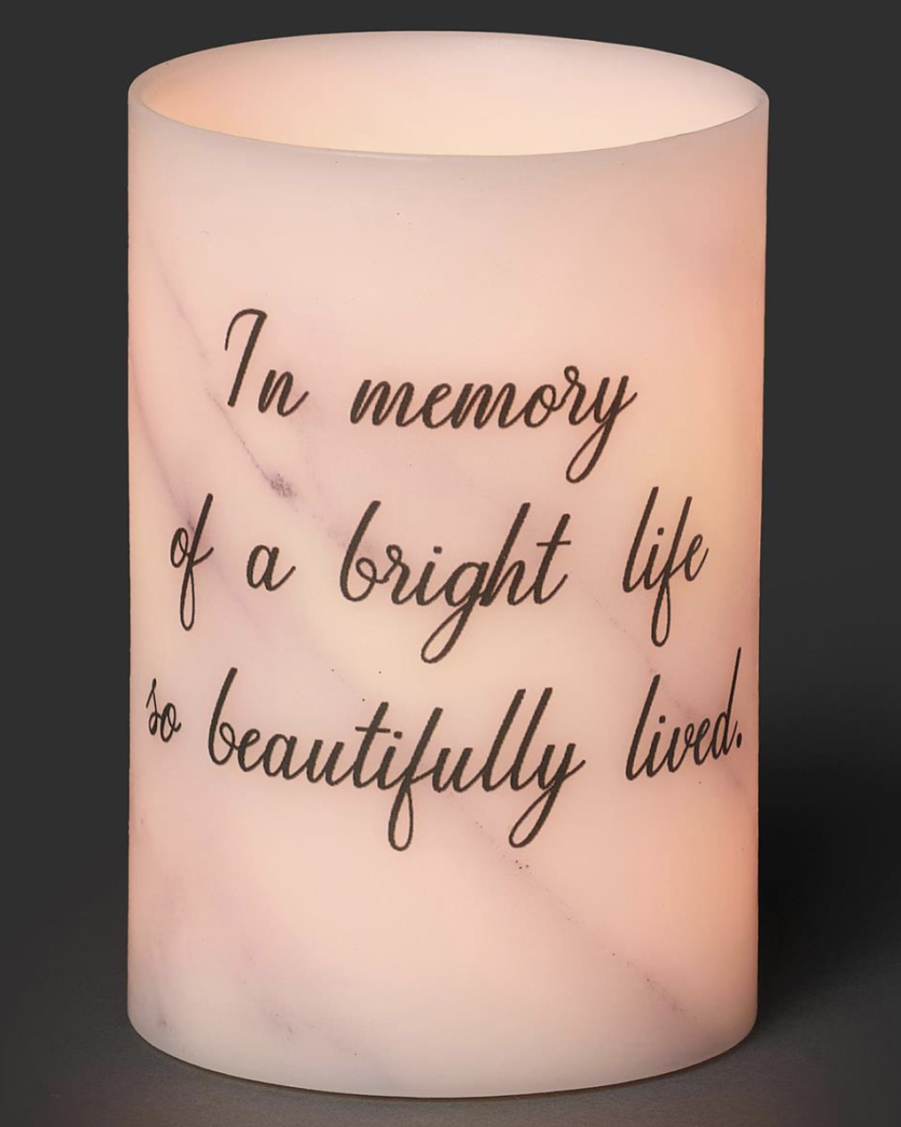 Flickering candle with text 'In memory of a bright life so beautifully lived' on a dark background