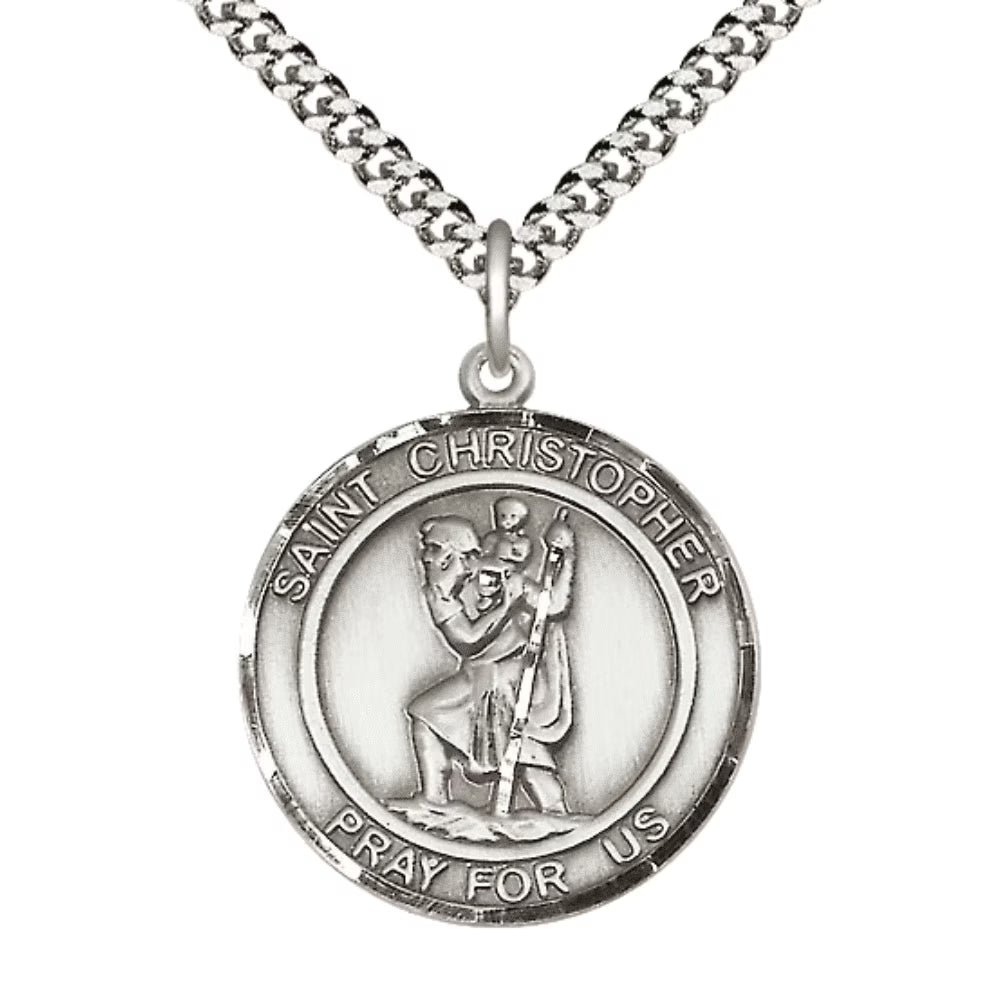 A silver Saint Christopher medal pendant on a matching curb chain necklace, shown against a plain white background.