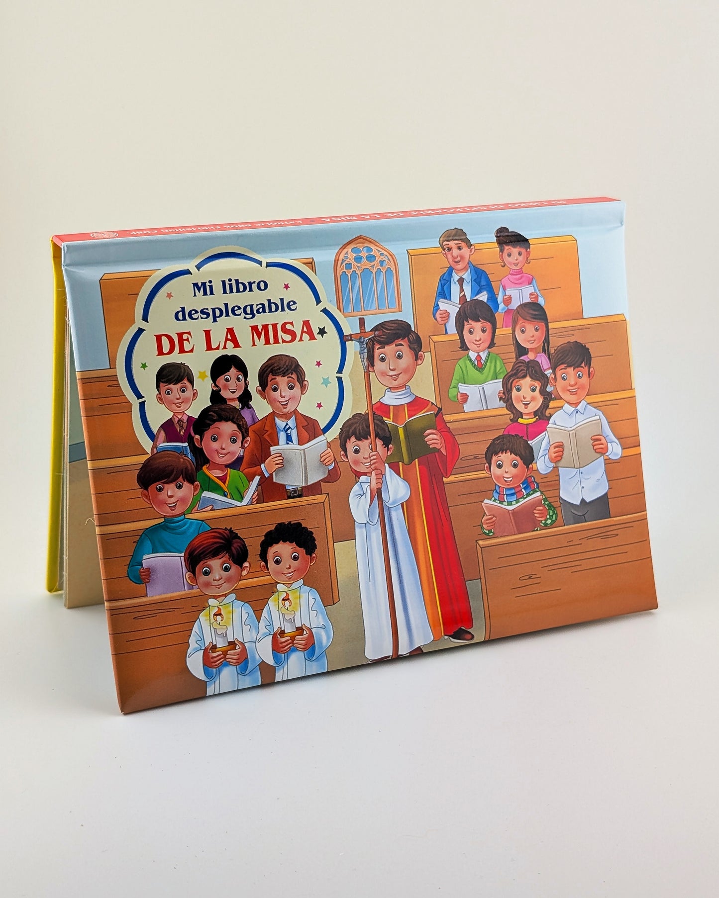 Children's book titled 'Mi libro desplegable de la Misa' with illustrations of children in a church setting on a white background.