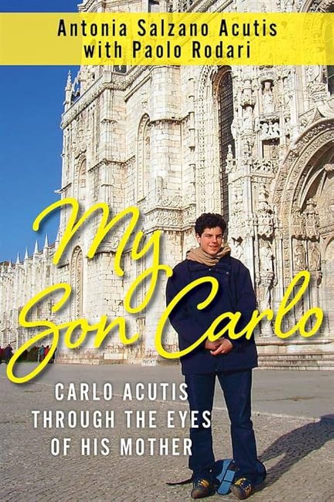 A book cover featuring the title 'My Son Carlo' with the subtitle 'Carlo Acutis through the eyes of his mother'. The cover image shows a young man, Carlo Acutis, standing in front of a building that appears to be a cathedral or a similar place of worship.