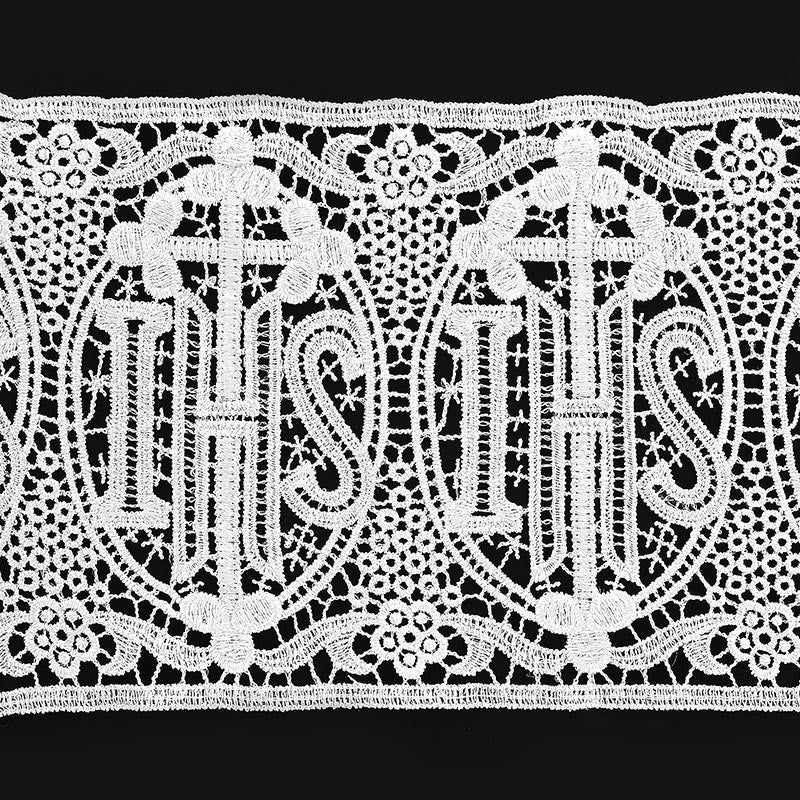 Decorative lace trim with 'IHS' symbol on a black background