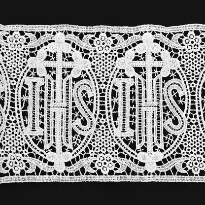 Decorative lace trim with 'IHS' symbol on a black background