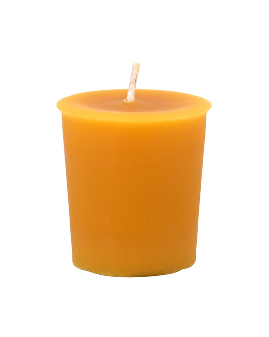 Yellow candle in a holder on a white background
