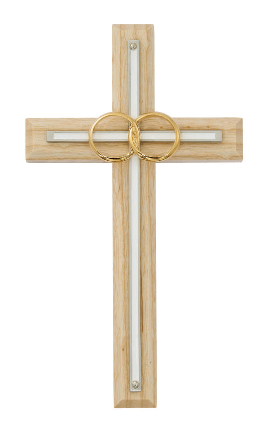 A stained oak wood cross with white enamel inlay and brass wedding rings.