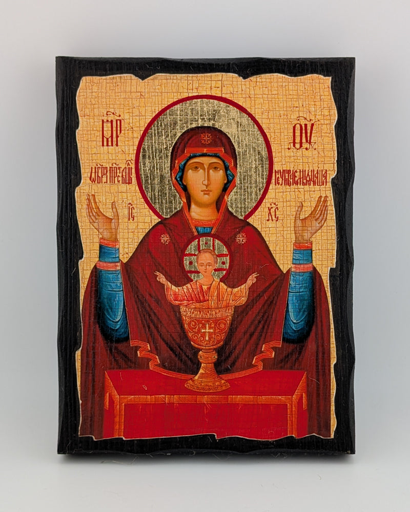 Decorative Orthodox icon with religious figure holding a child on a beige background