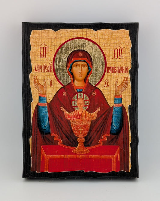 Decorative Orthodox icon with religious figure holding a child on a beige background