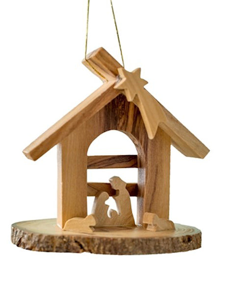 Wooden nativity scene ornament with stable and figures on a white background