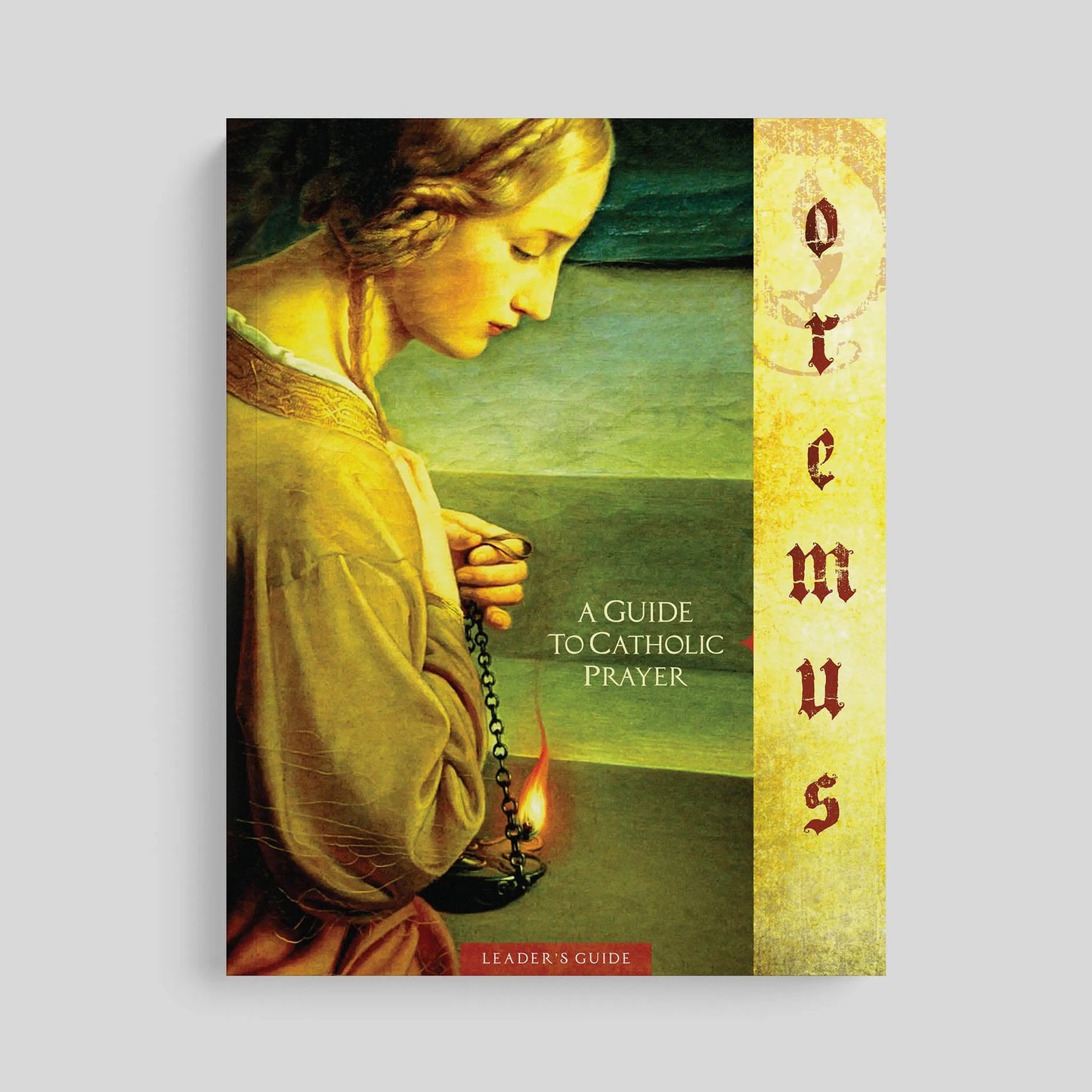 Book cover of 'Oremus: A Guide to Catholic Prayer' with a classical painting of a woman praying on a gray background.