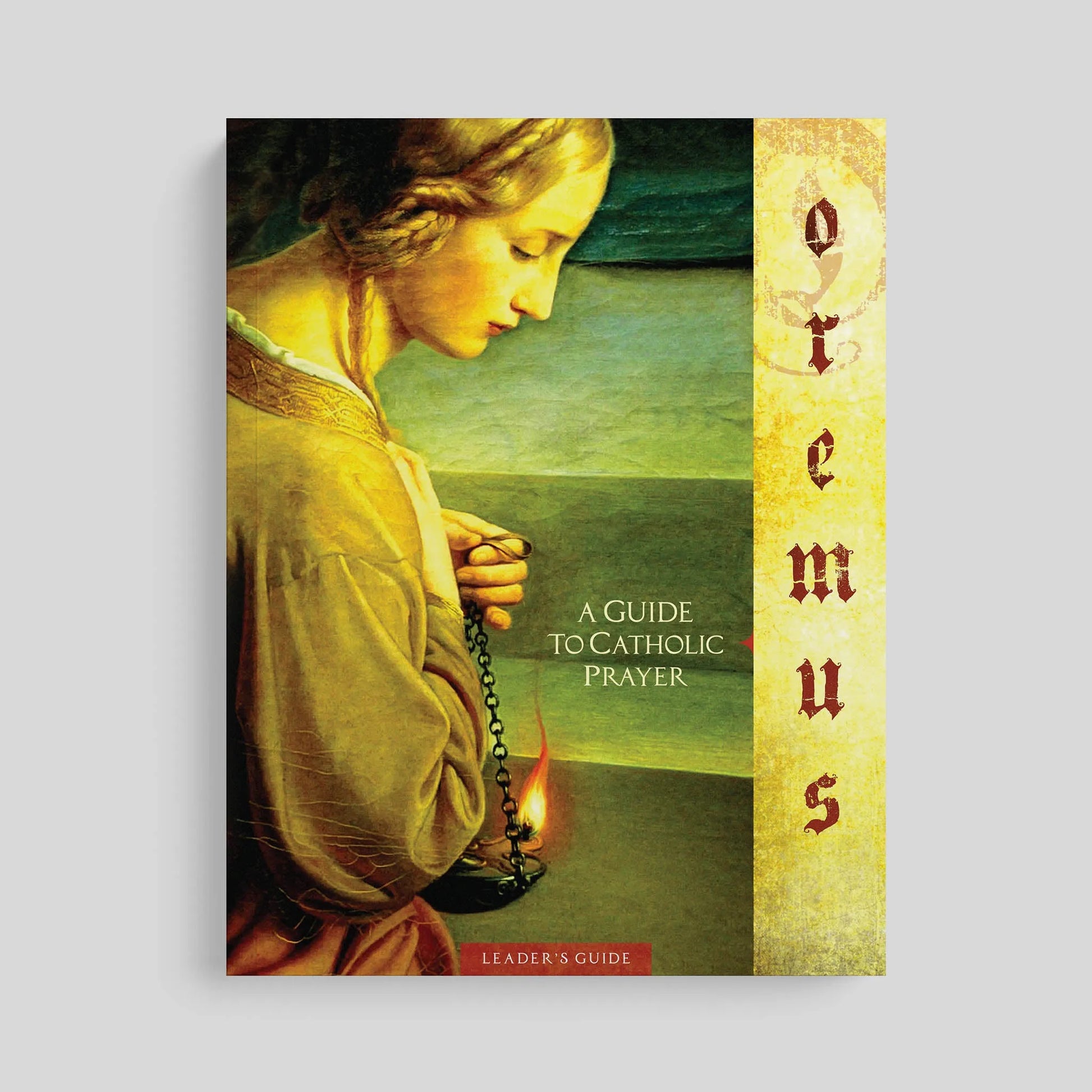Book cover of 'Oremus: A Guide to Catholic Prayer' with a classical painting of a woman praying on a gray background.