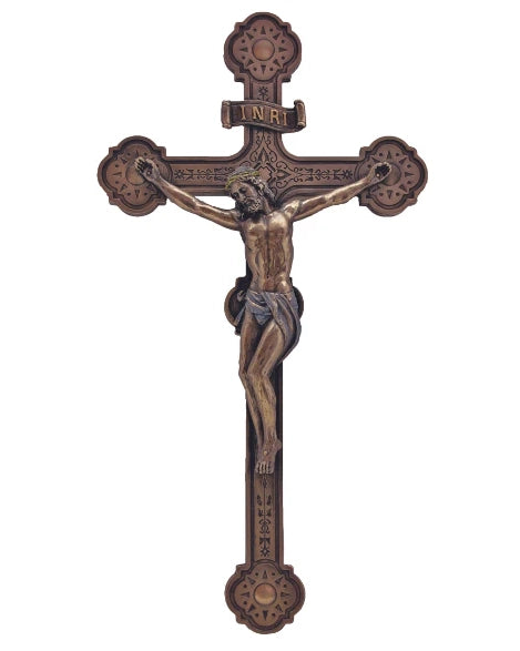 Bronze crucifix with detailed design on a white background