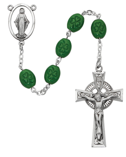 Rosary with green beads and silver crucifix on a white background