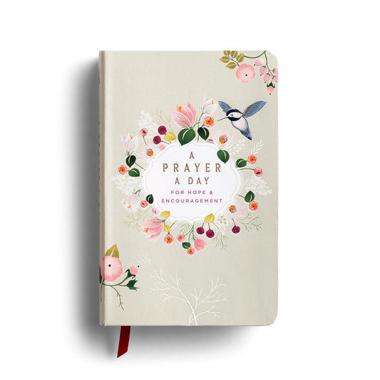 A Prayer A Day for Hope & Encouragement, a hardcover book with floral designs and a red ribbon bookmark.
