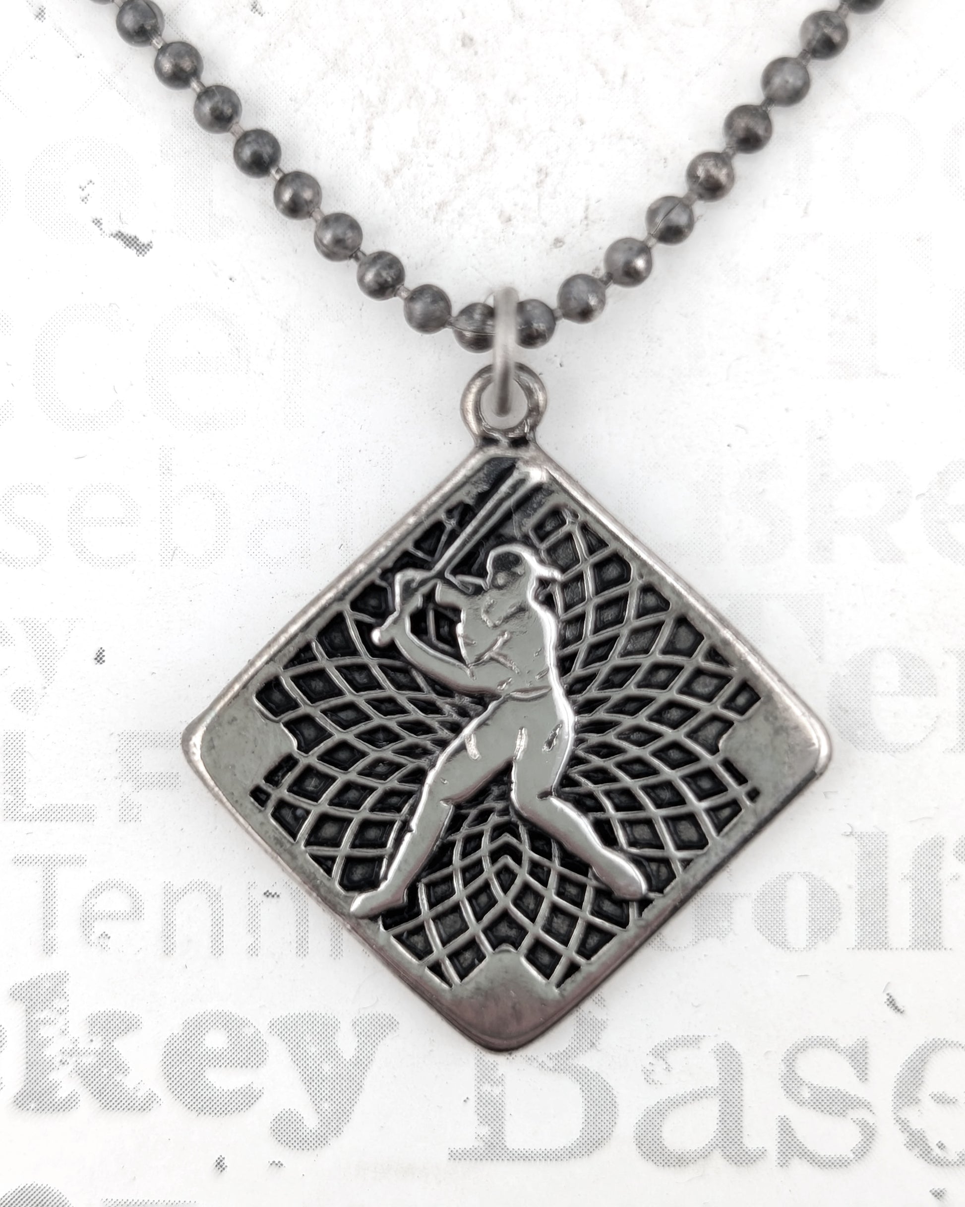 Silver pendant necklace with a detailed design on a white background