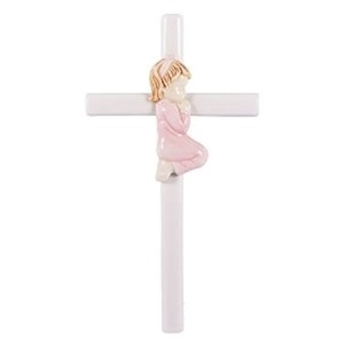 A white porcelain wall cross featuring a central figure of a baby girl in a pink dress praying, with a gold-colored cross and a white background.