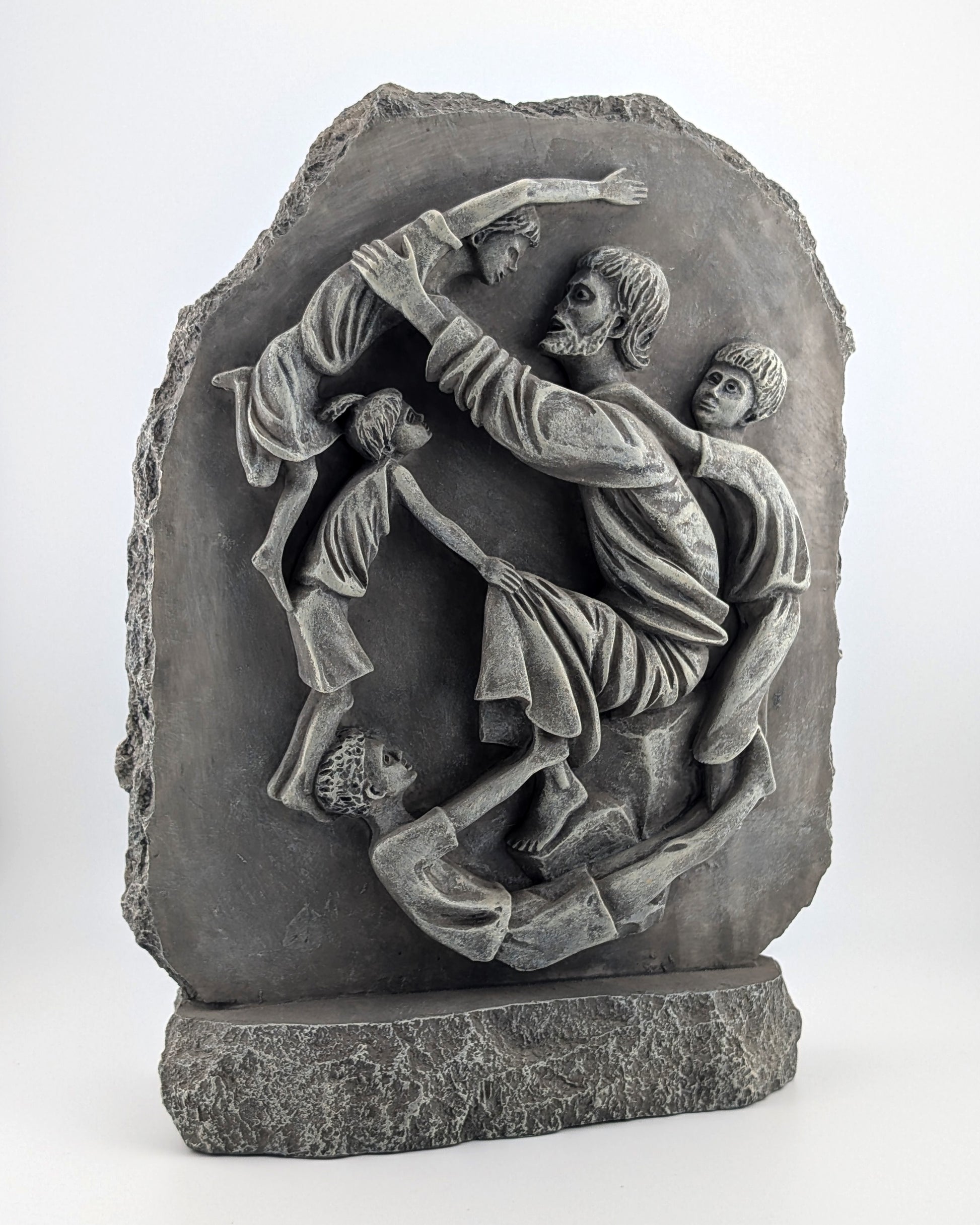 Stone sculpture depicting a scene with people, possibly a historical or mythological event, on a white background.