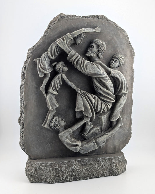 Stone sculpture depicting a scene with people, possibly a historical or mythological event, on a white background.