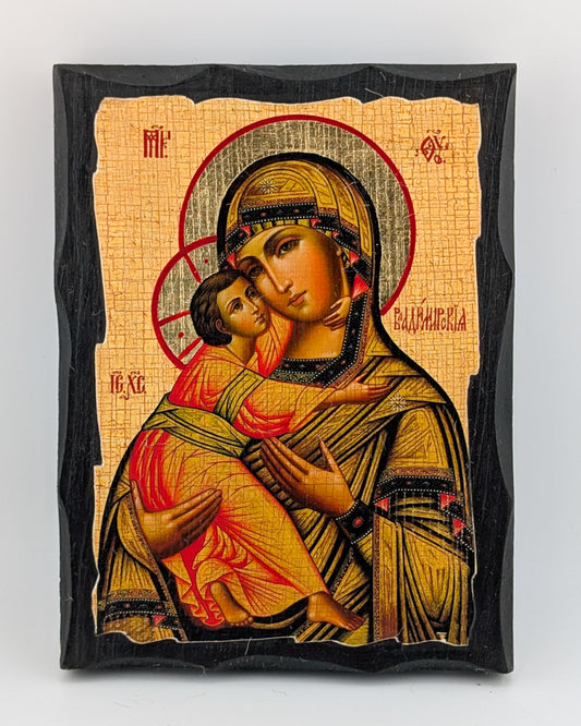 Byzantine-styele Orthodox Icon of a religious figure holding a child with intricate details on a beige background